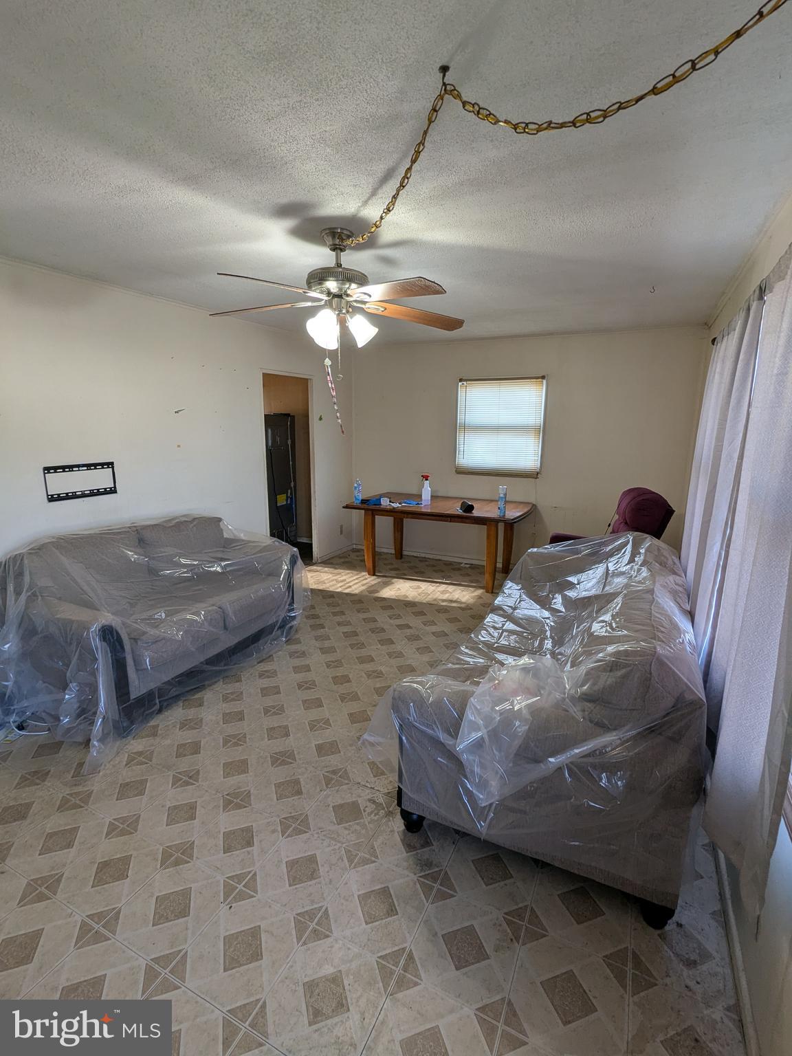 1502 3rd Avenue Bridgeton, NJ 08302 - Photo 4 of 15 a spacious bedroom with a bed and a chandelier