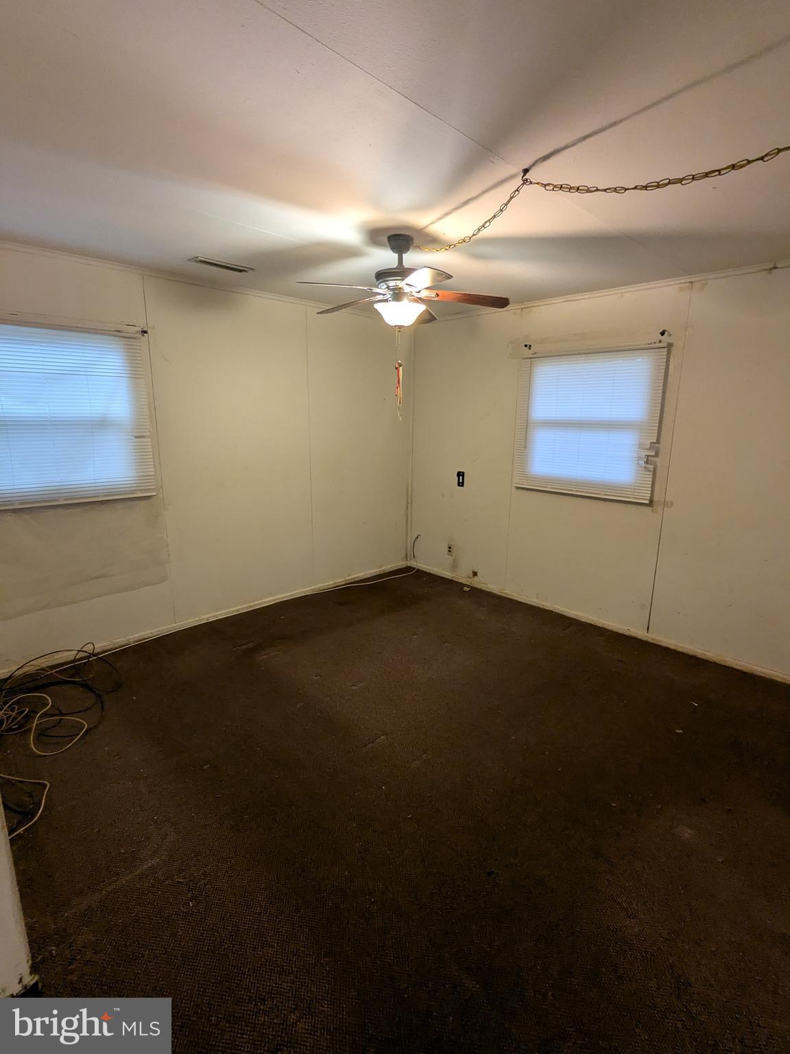 1502 3rd Avenue Bridgeton, NJ 08302 - Photo 8 of 15 an empty room with a ceiling fan and a window