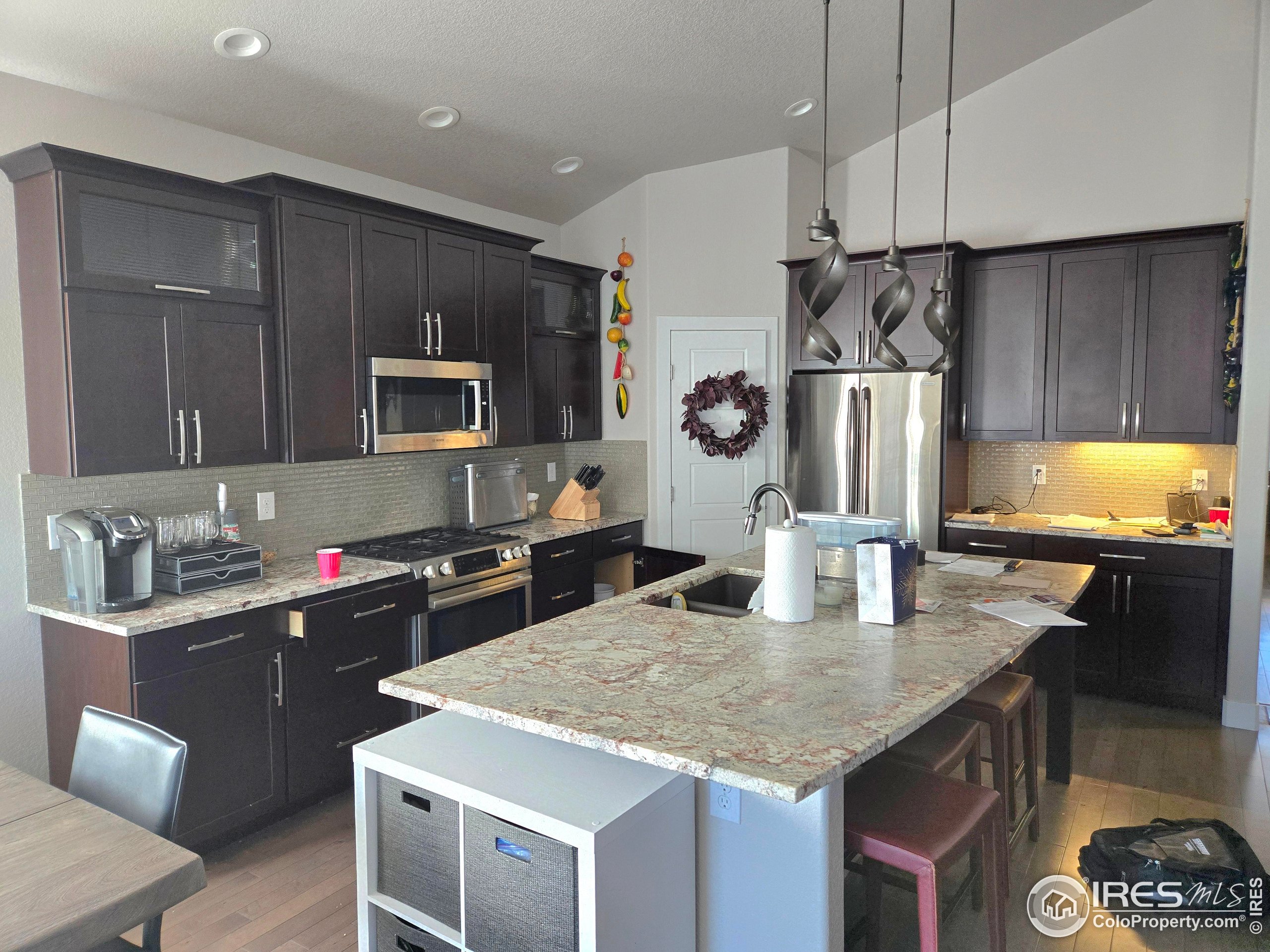 7292 McClellan Road Wellington, CO 80549 - Photo 17 of 19 a kitchen with stainless steel appliances granite countertop a sink stove and refrigerator