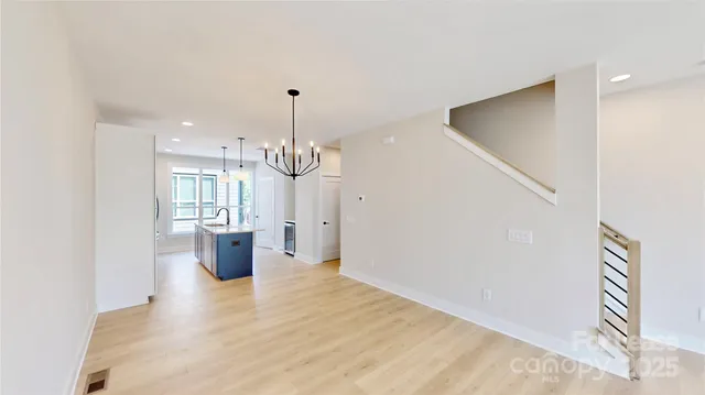 a view of empty room with wooden floor and window