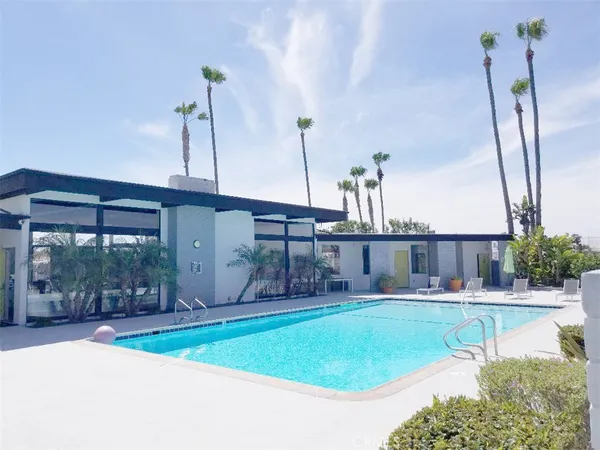 a view of a swimming pool with outdoor seating