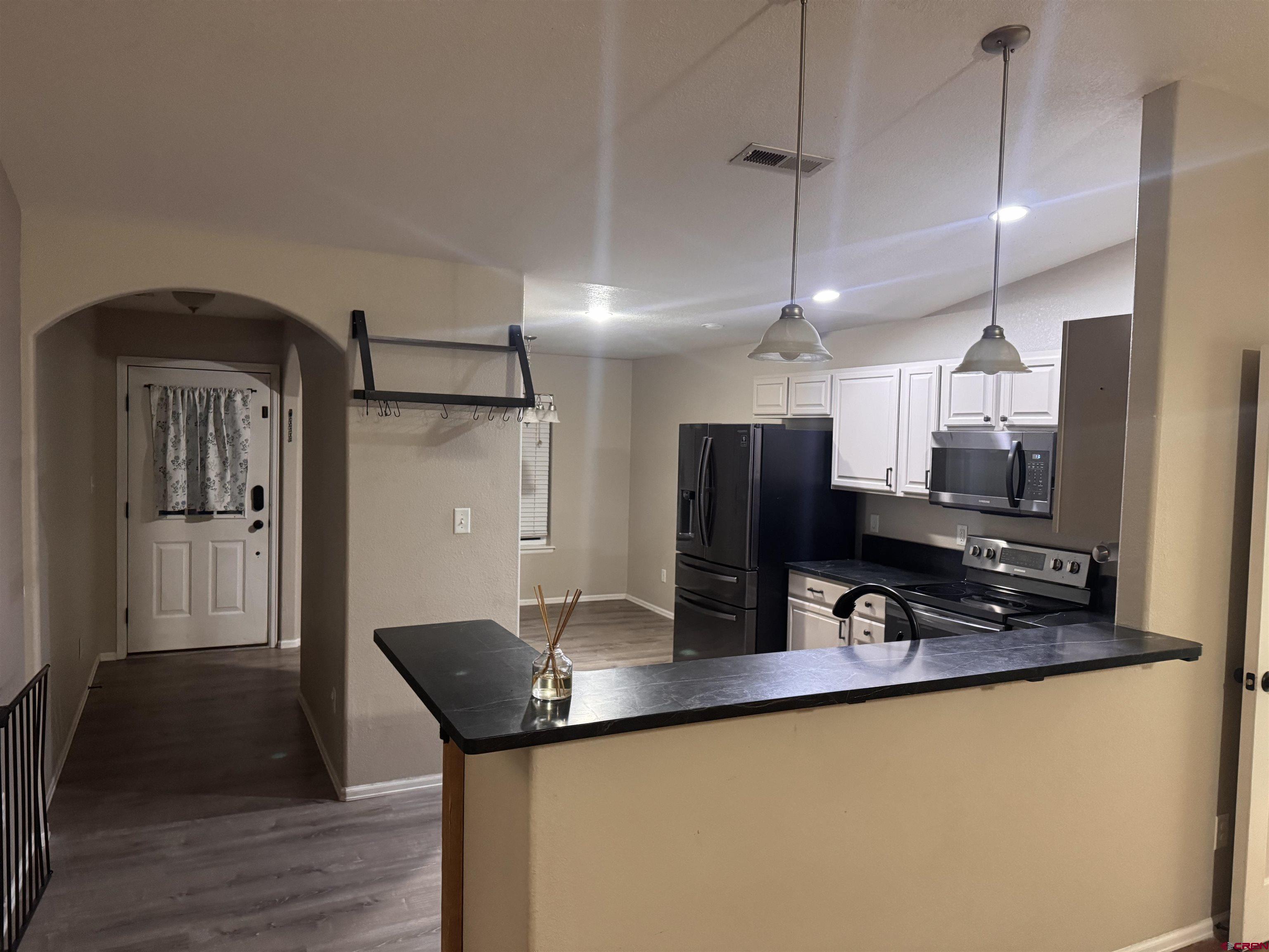 1984 Sapphire Way Delta, CO 81416 - Photo 13 of 22 a kitchen with stainless steel appliances granite countertop a sink a refrigerator and a stove