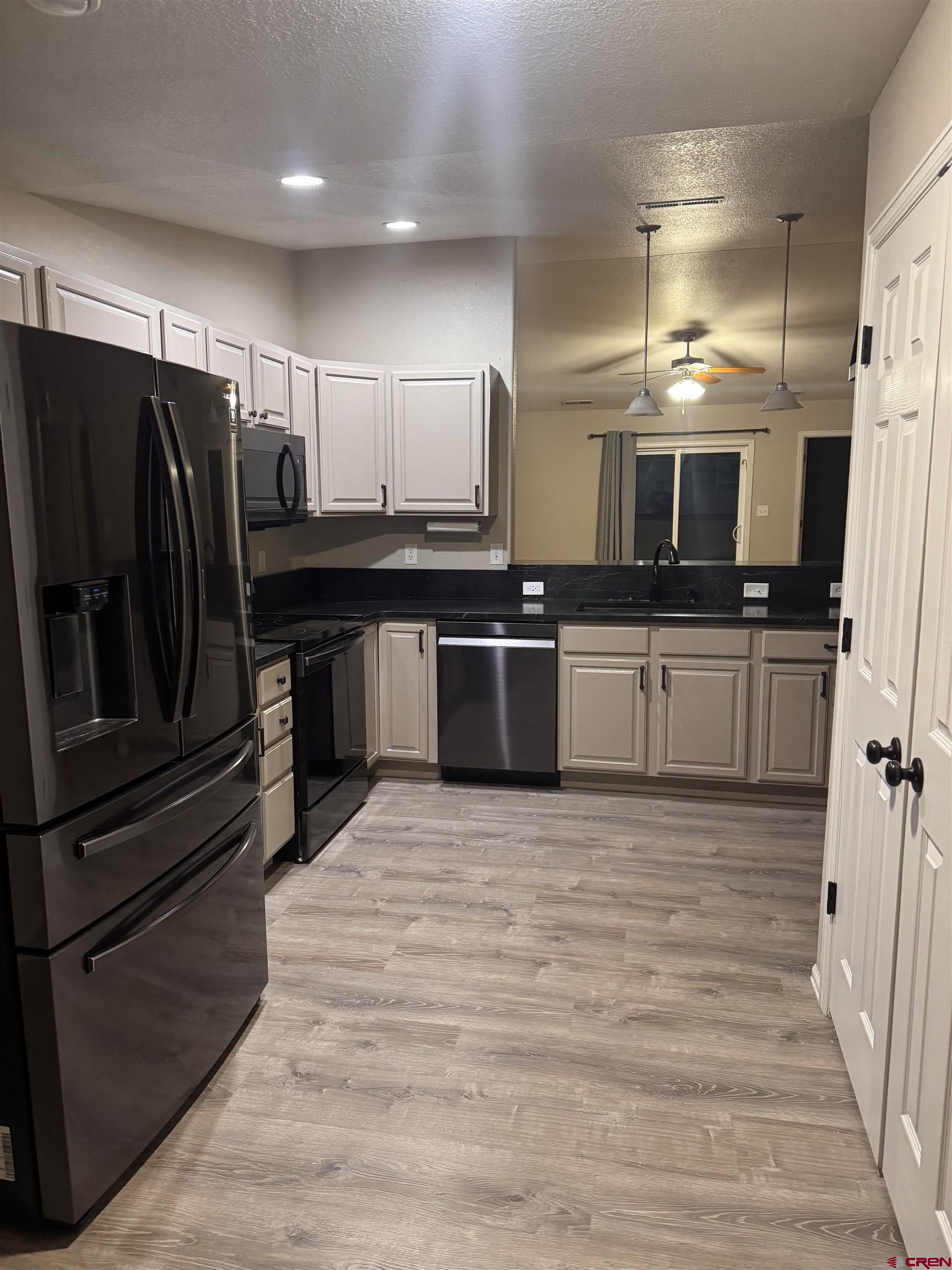 1984 Sapphire Way Delta, CO 81416 - Photo 16 of 22 a kitchen with stainless steel appliances kitchen island granite countertop a refrigerator oven a sink and dishwasher