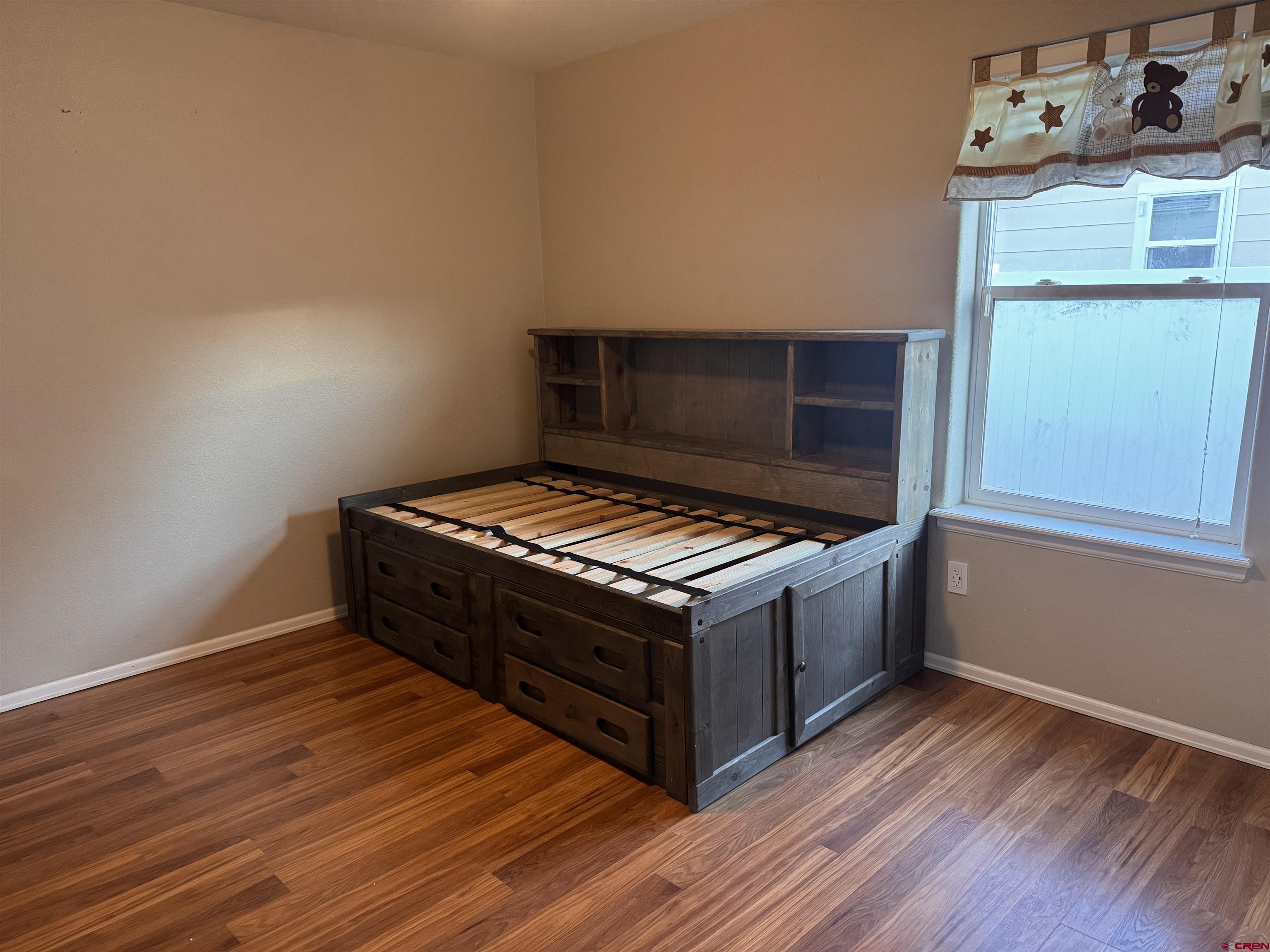 1984 Sapphire Way Delta, CO 81416 - Photo 18 of 22 a room with wooden floors and flat screen tv