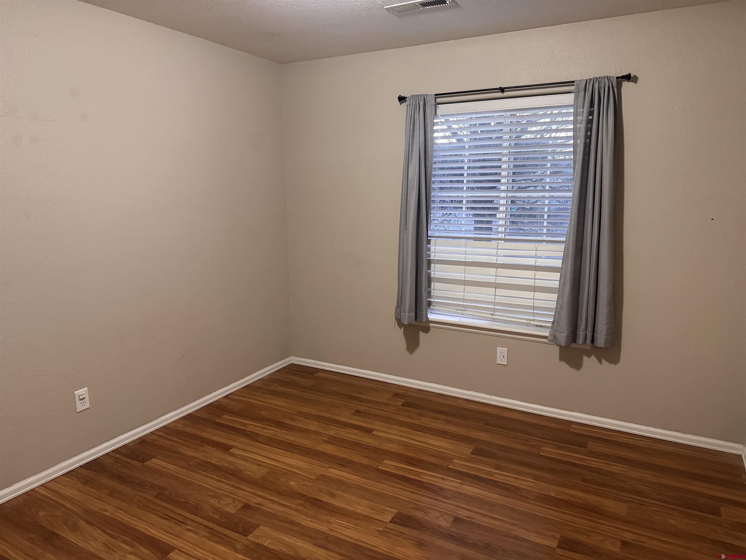 1984 Sapphire Way Delta, CO 81416 - Photo 19 of 22 a view of a room with wooden floor and a window