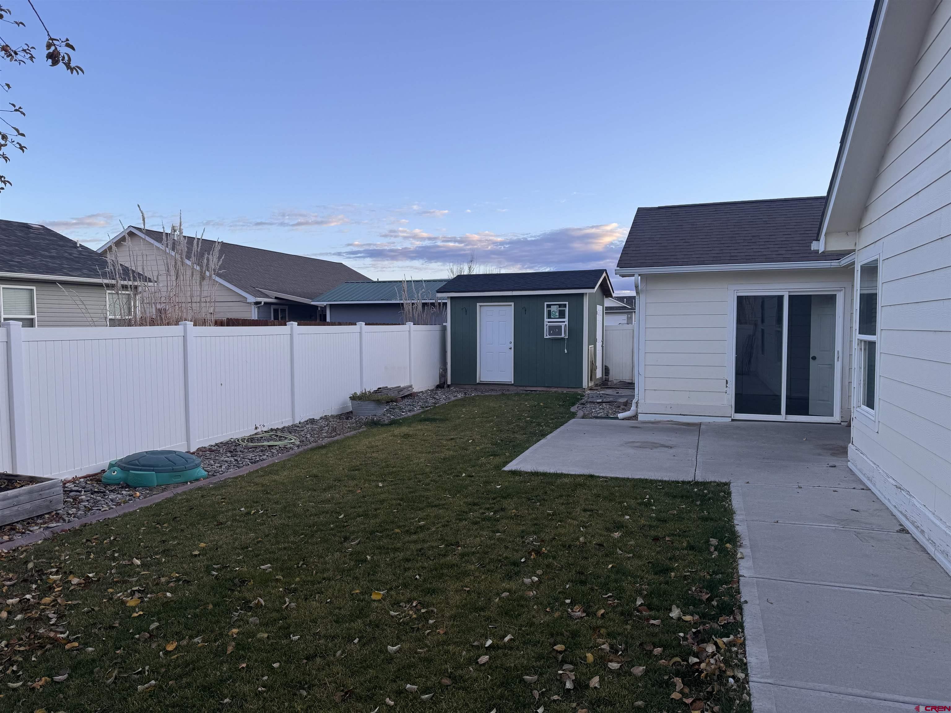 1984 Sapphire Way Delta, CO 81416 - Photo 2 of 22 a front view of a house with yard and garage