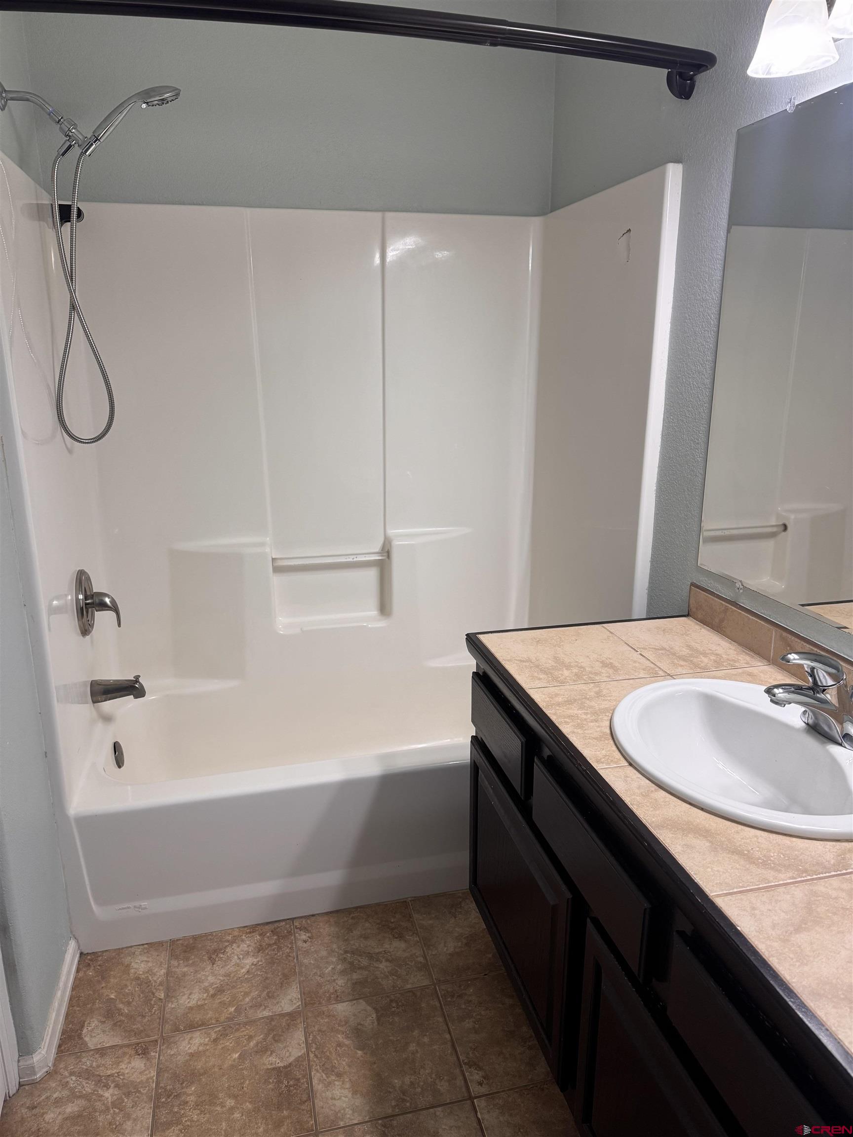 1984 Sapphire Way Delta, CO 81416 - Photo 21 of 22 a bathroom with a granite countertop sink a toilet and bathtub