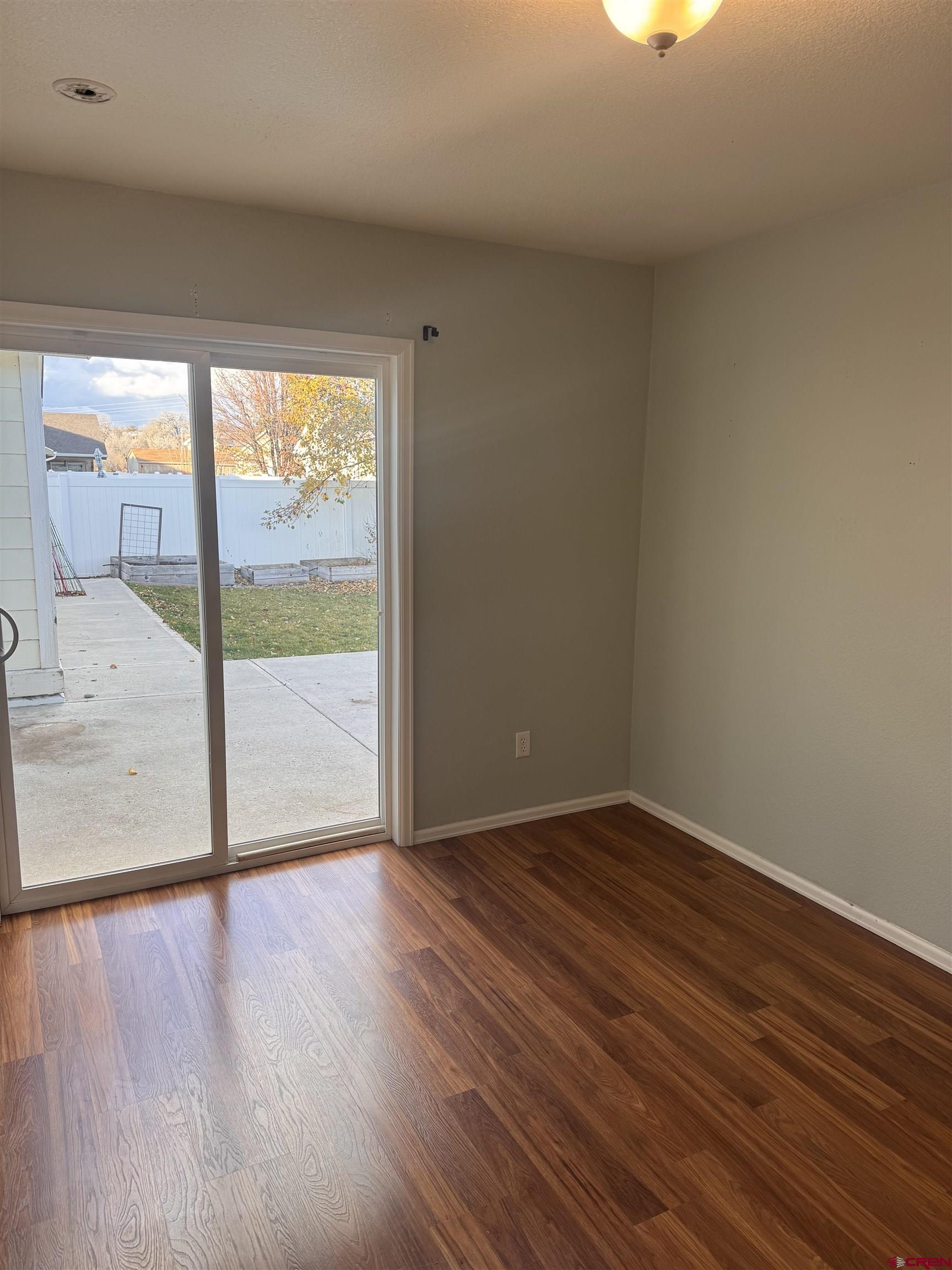 1984 Sapphire Way Delta, CO 81416 - Photo 10 of 22 a view of an empty room with wooden floor and a window