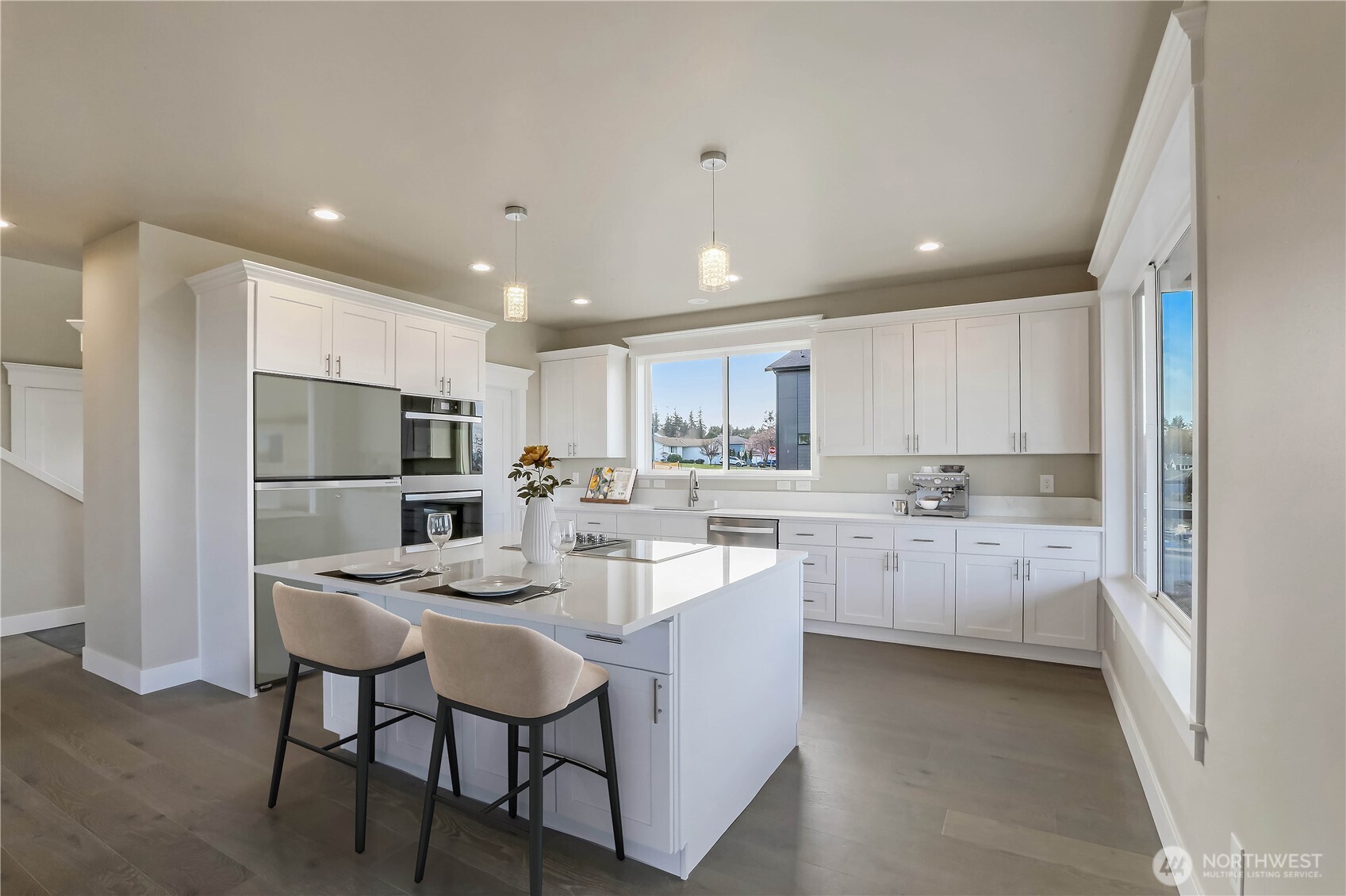 3706 West 3rd Street Anacortes, WA 98221 - Photo 12 of 40 a kitchen with white cabinets and stainless steel appliances