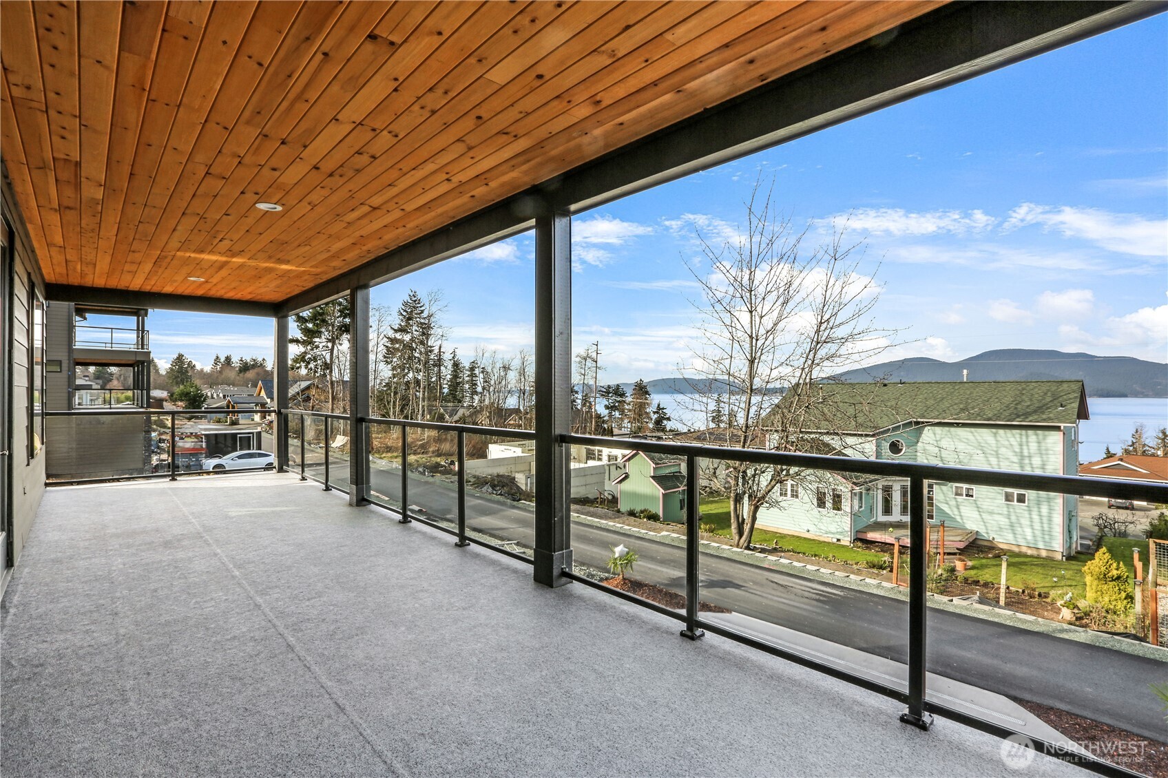 3706 West 3rd Street Anacortes, WA 98221 - Photo 16 of 40 a view of an chairs and tables in the balcony