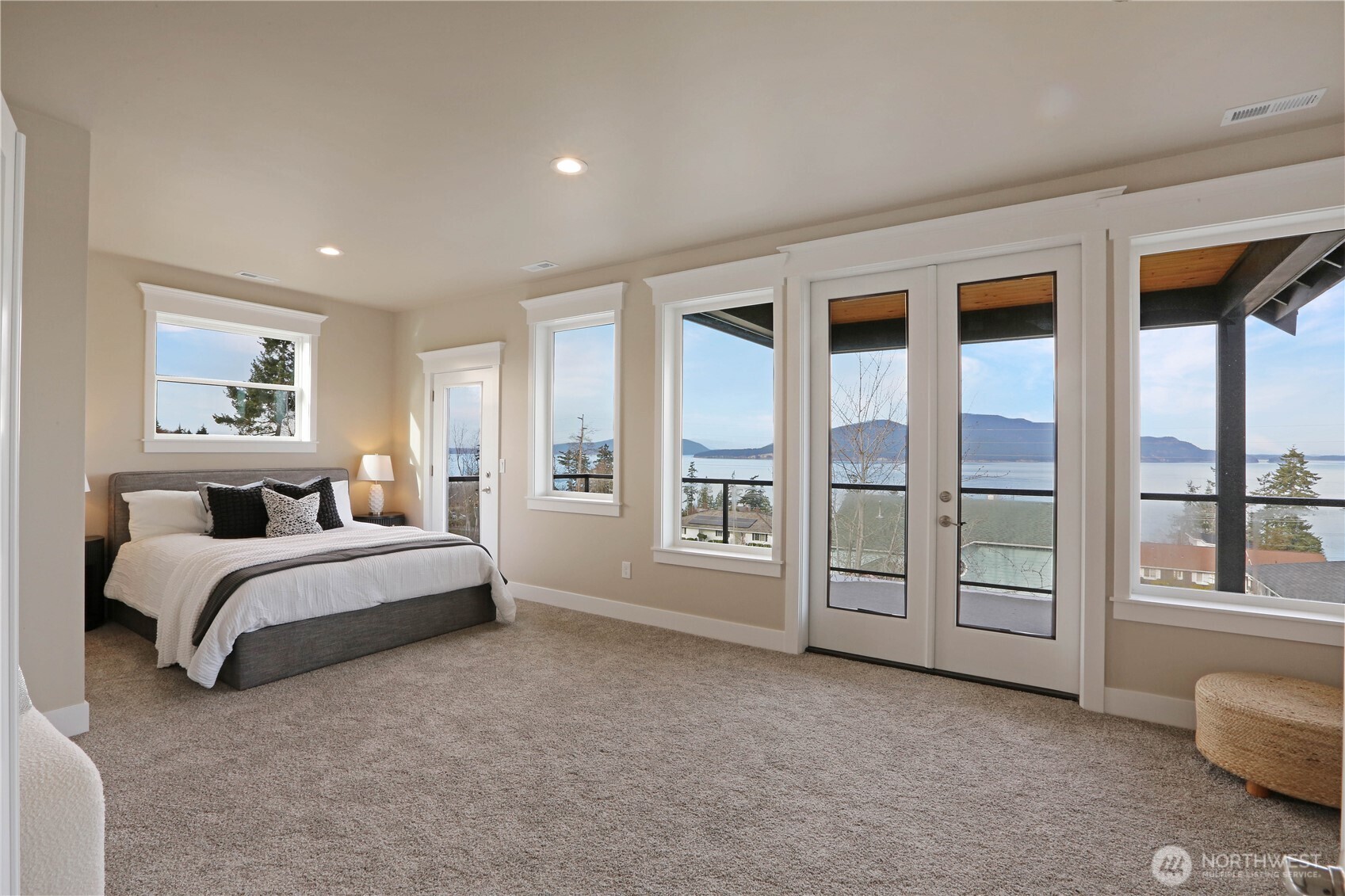 3706 West 3rd Street Anacortes, WA 98221 - Photo 29 of 40 a spacious bedroom with a bed and a large window