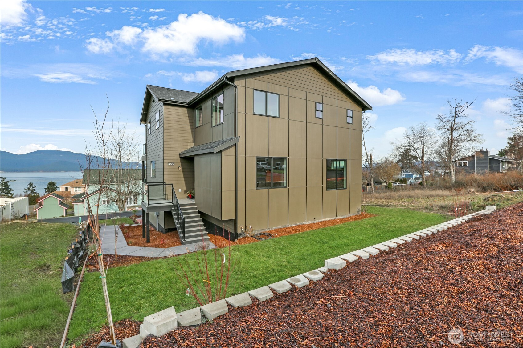 3706 West 3rd Street Anacortes, WA 98221 - Photo 7 of 40 a front view of a house with a yard