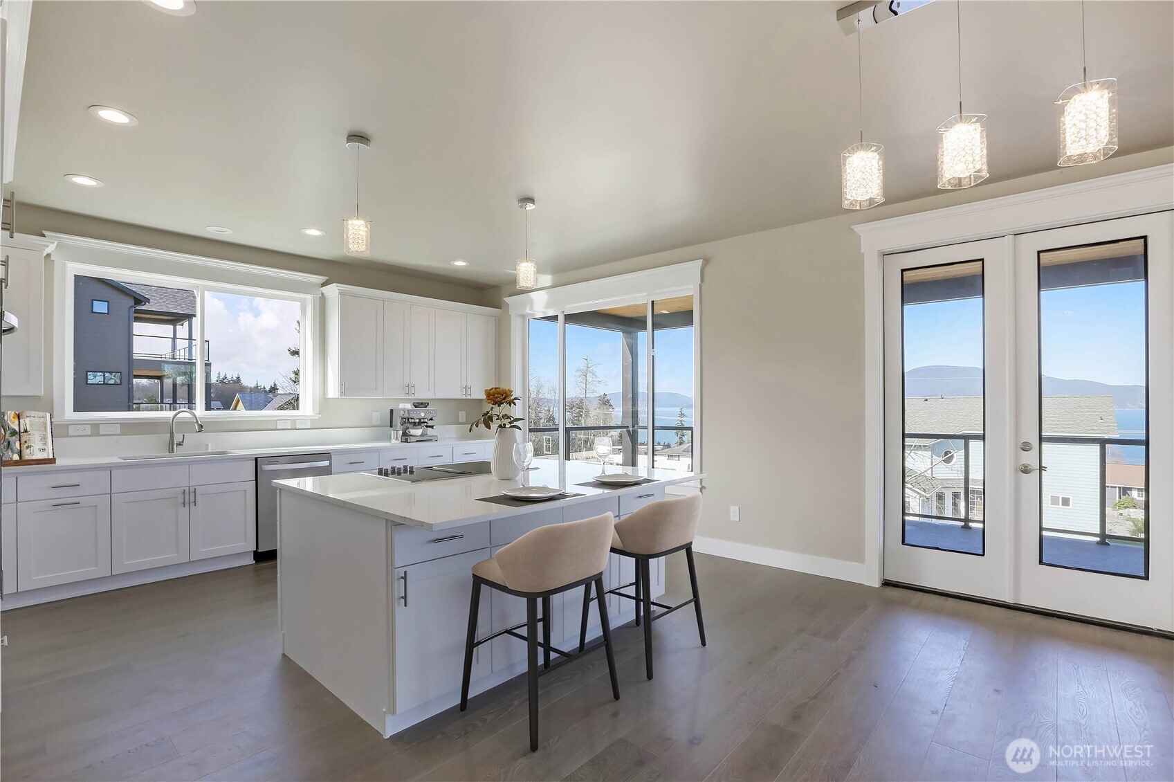 3706 West 3rd Street Anacortes, WA 98221 - Photo 9 of 40 a kitchen with sink a stove and chairs