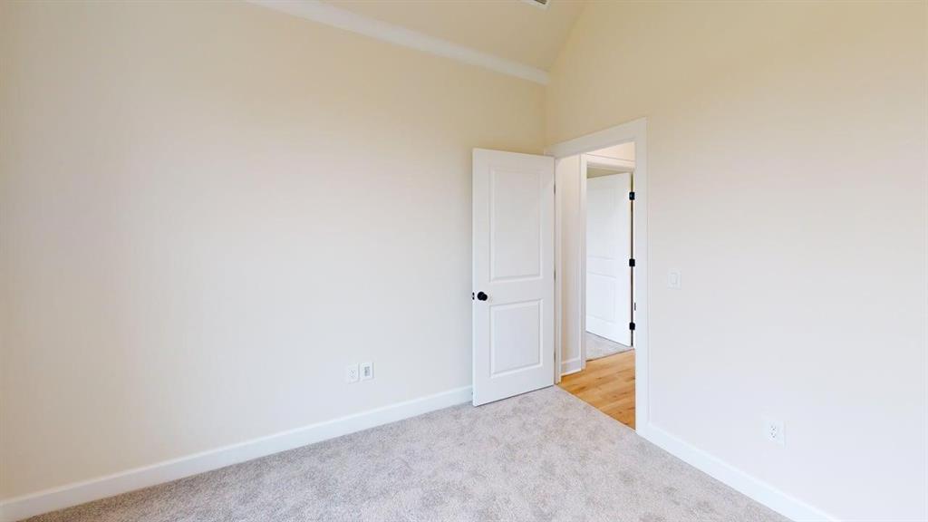2509 Windmill Lane Longview, TX 75601 - Photo 24 of 35 Spare room featuring carpet flooring and high vaulted ceiling
