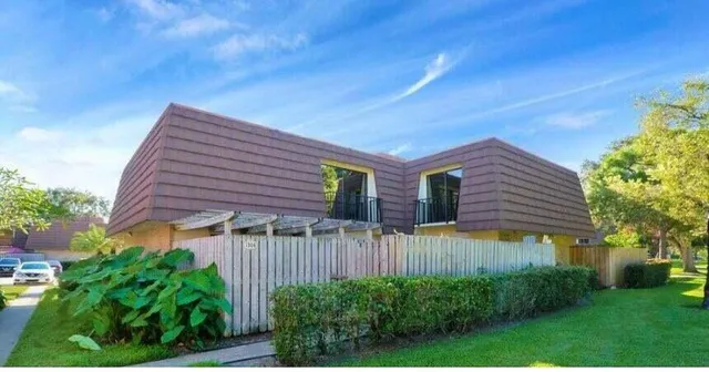 a view of a house with a yard and plants