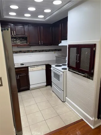 a kitchen with a wooden floor and a stove top oven