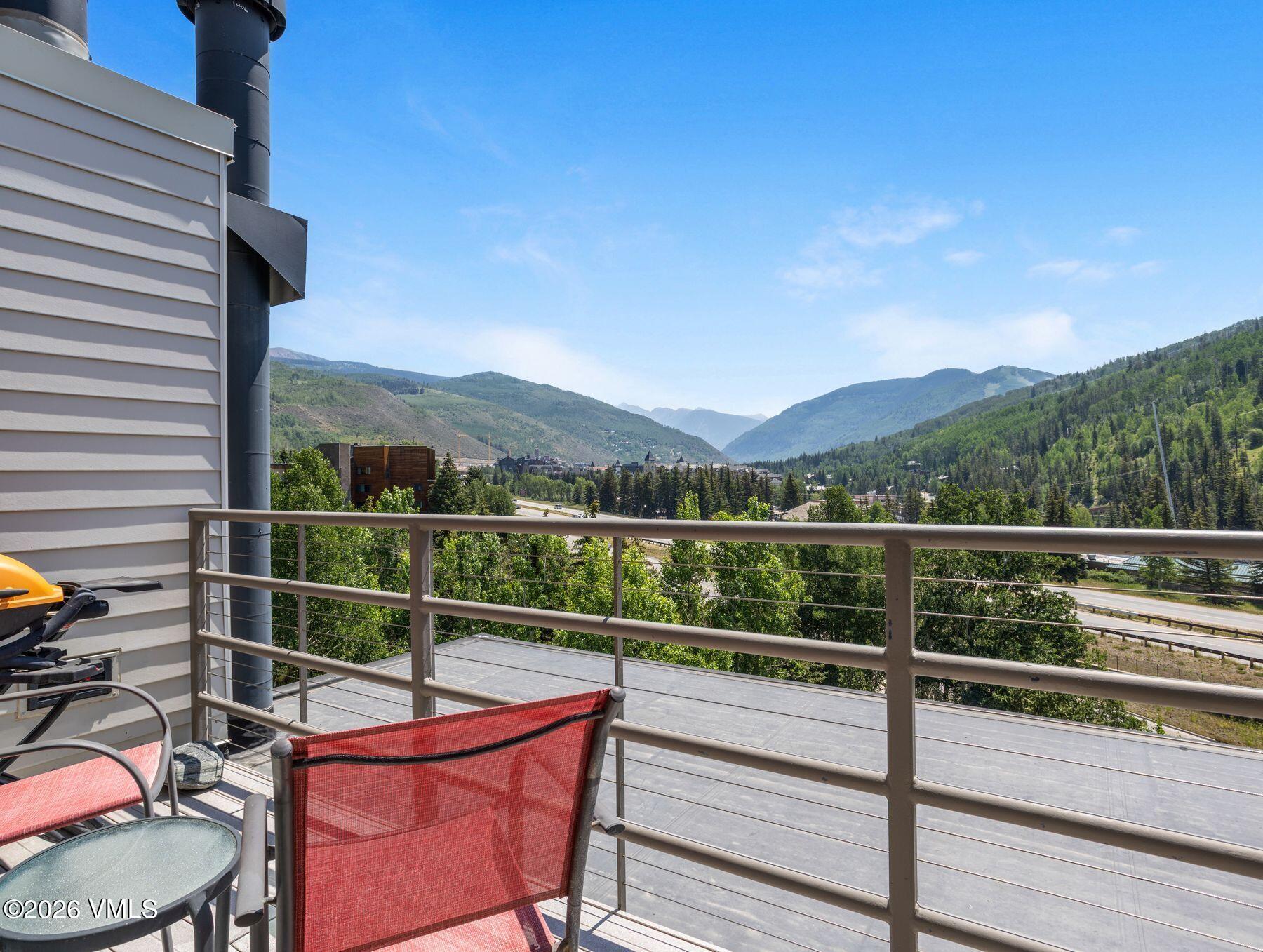 1100 North Frontage Road West, Unit 1503 Vail, CO 81657 - Photo 8 of 32 a view of a balcony with mountain view and wooden floor