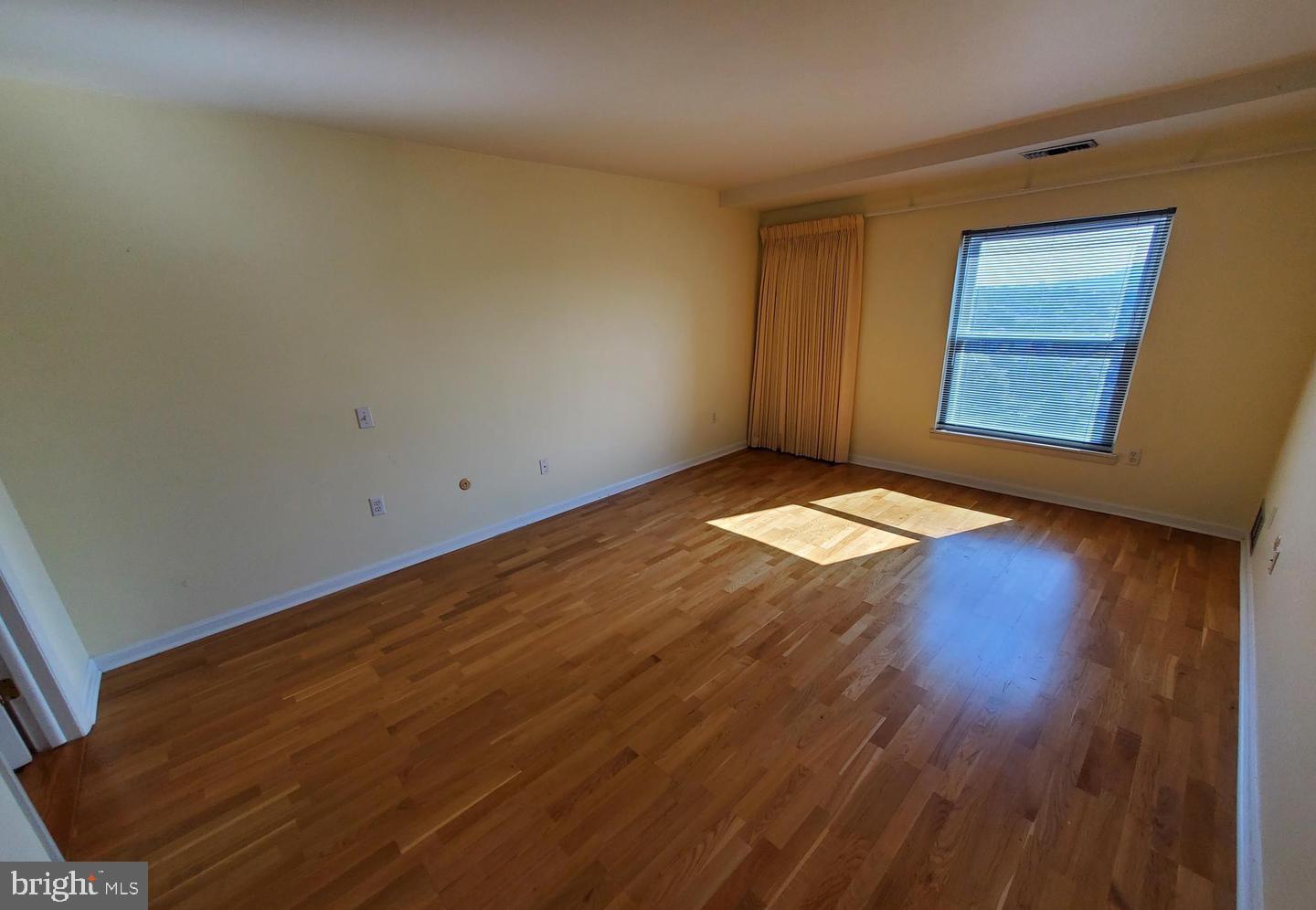1375 Pershing Boulevard, Unit 810 Reading, PA 19607 - Photo 12 of 21 an empty room with wooden floor and windows