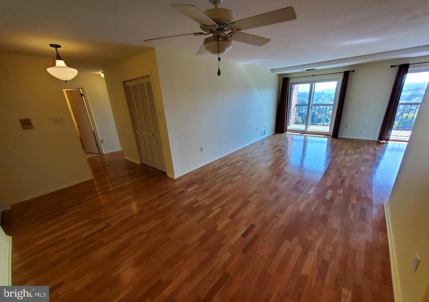 1375 Pershing Boulevard, Unit 810 Reading, PA 19607 - Photo 4 of 21 a view of a livingroom with wooden floor and a ceiling fan