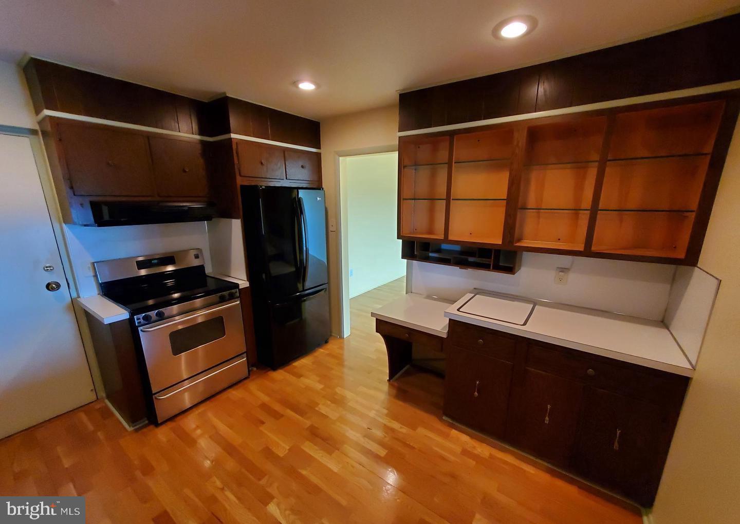 1375 Pershing Boulevard, Unit 810 Reading, PA 19607 - Photo 9 of 21 a kitchen with stainless steel appliances kitchen island granite countertop a refrigerator and a stove top oven