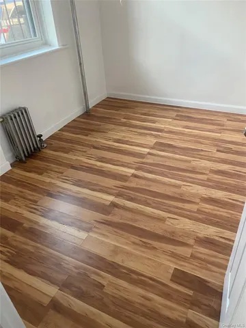 a view of a room with wooden floor