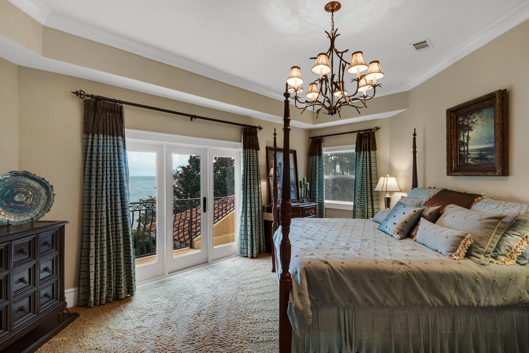 1239 Driftwood Point Road Santa Rosa Beach, FL 32459 - Photo 54 of 66 a bedroom with a large bed and a chandelier