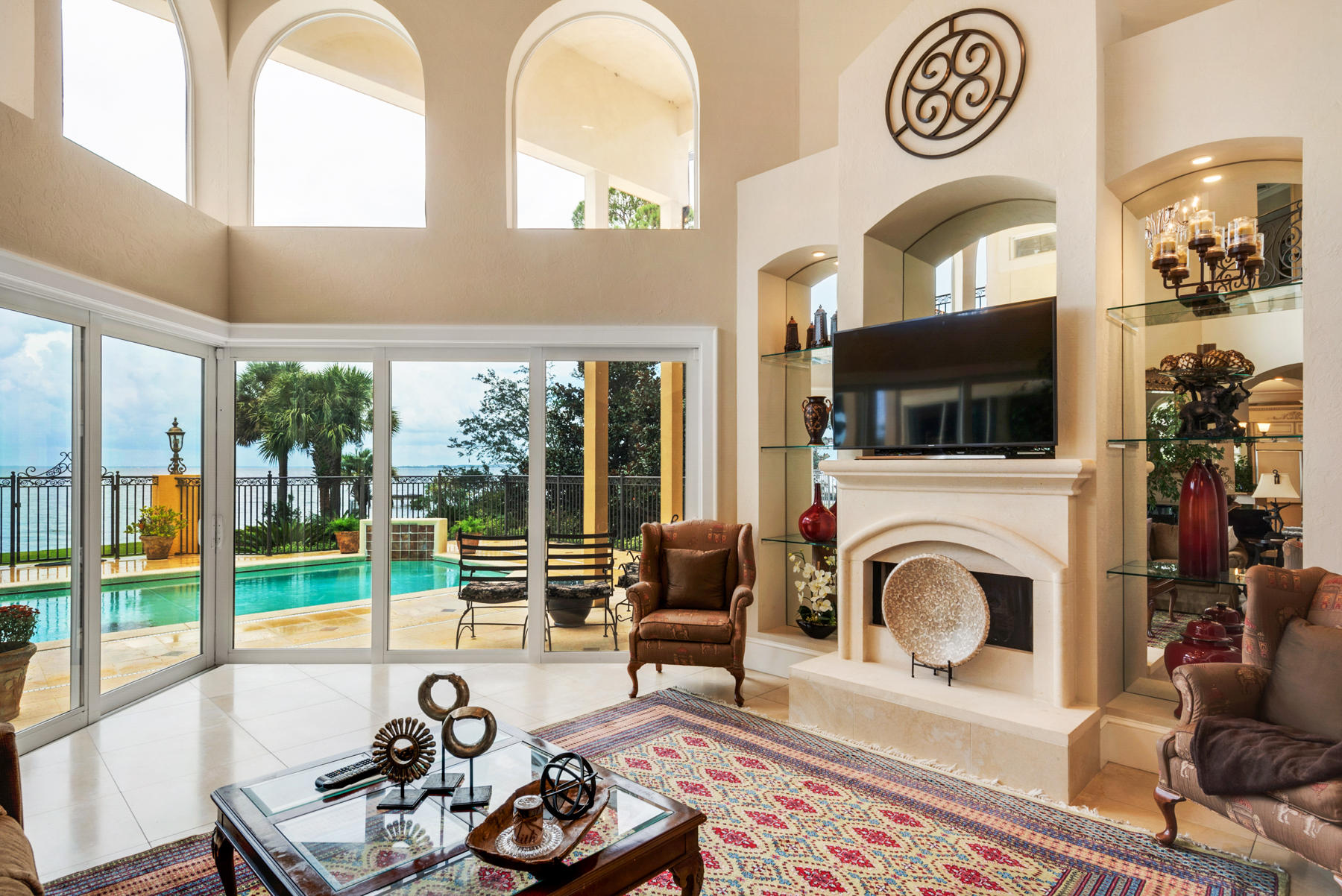 1239 Driftwood Point Road Santa Rosa Beach, FL 32459 - Photo 10 of 66 a living room with furniture a fireplace and a floor to ceiling window