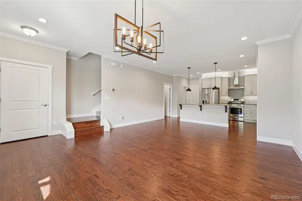 a view of an empty room and wooden floor