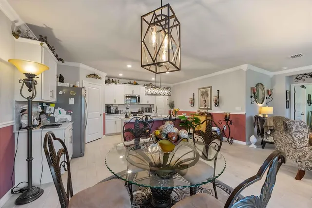 a view of a hallway with wooden floor and a potted plant