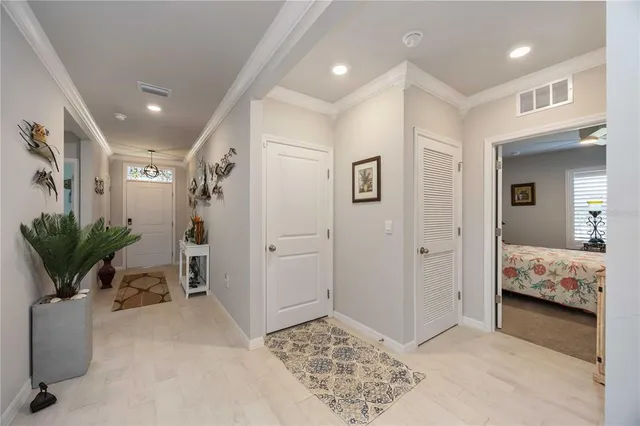 a living room with furniture and a baby crib