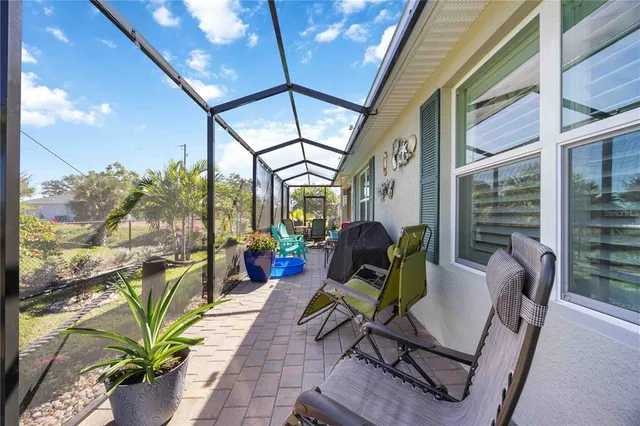a aerial view of a house with a yard and potted plants