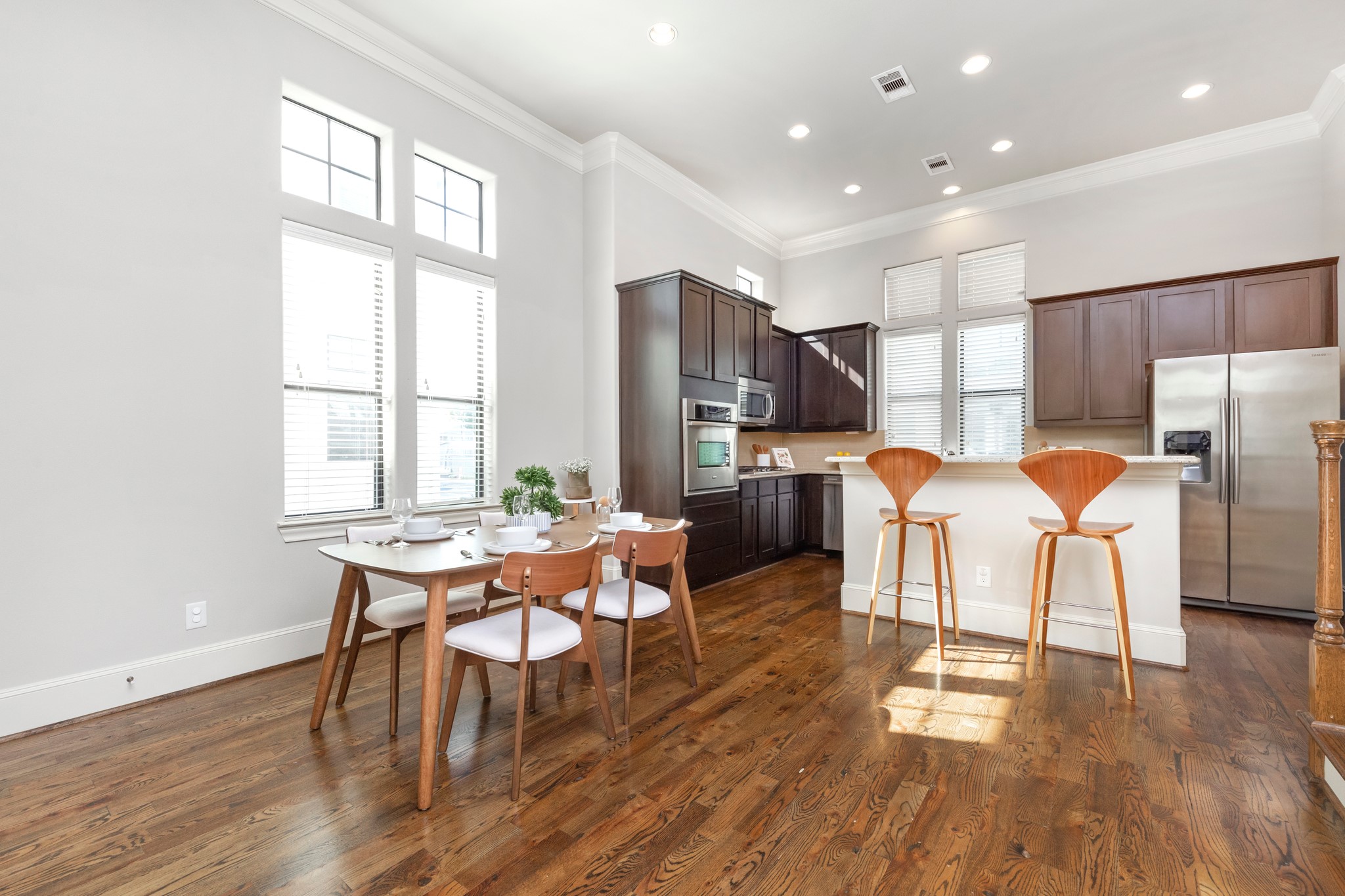 1406 Hickory Street Houston, TX 77007 - Photo 31 of 41 a kitchen with stainless steel appliances wooden floor dining table and chairs