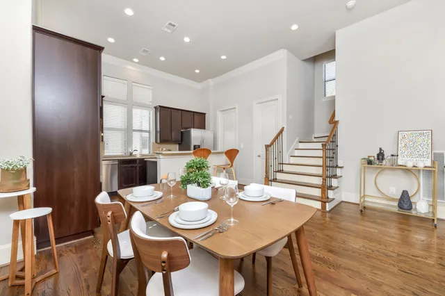 a view of a dining room with furniture and wooden floor