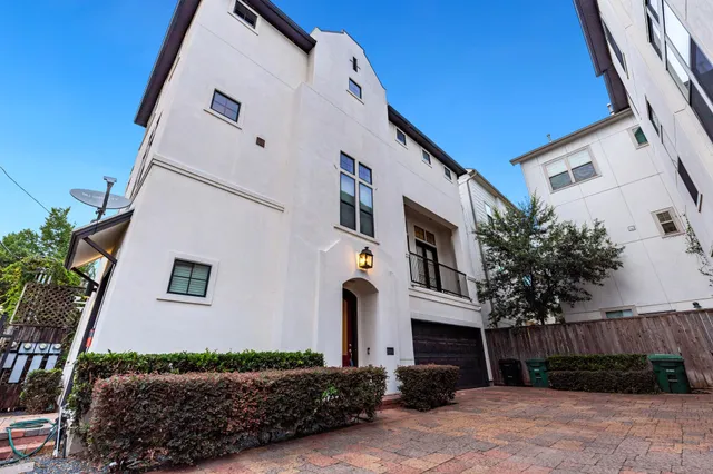 a front view of a house with plants
