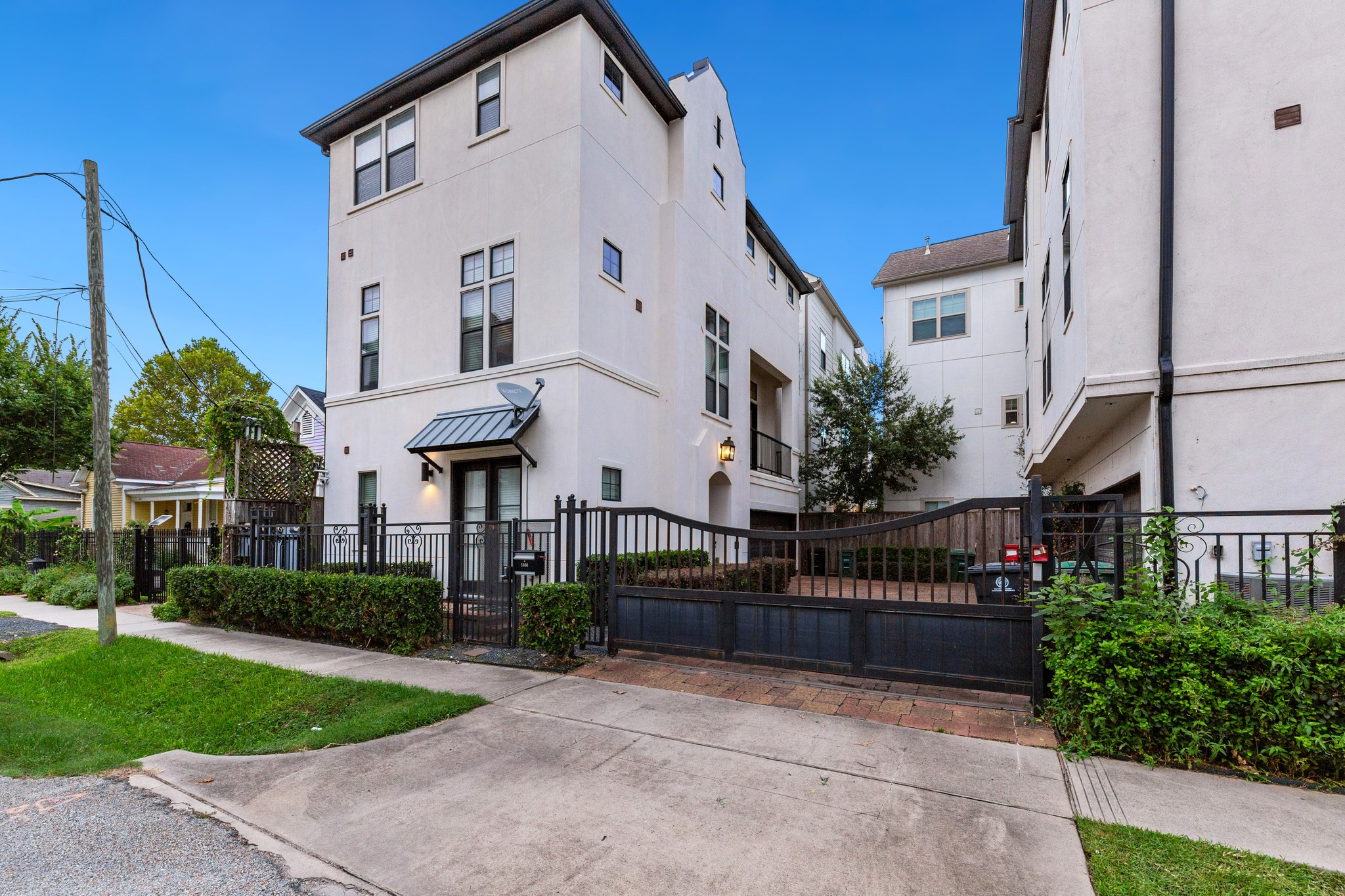 1406 Hickory Street Houston, TX 77007 - Photo 6 of 41 a view of a white house with a small yard and plants