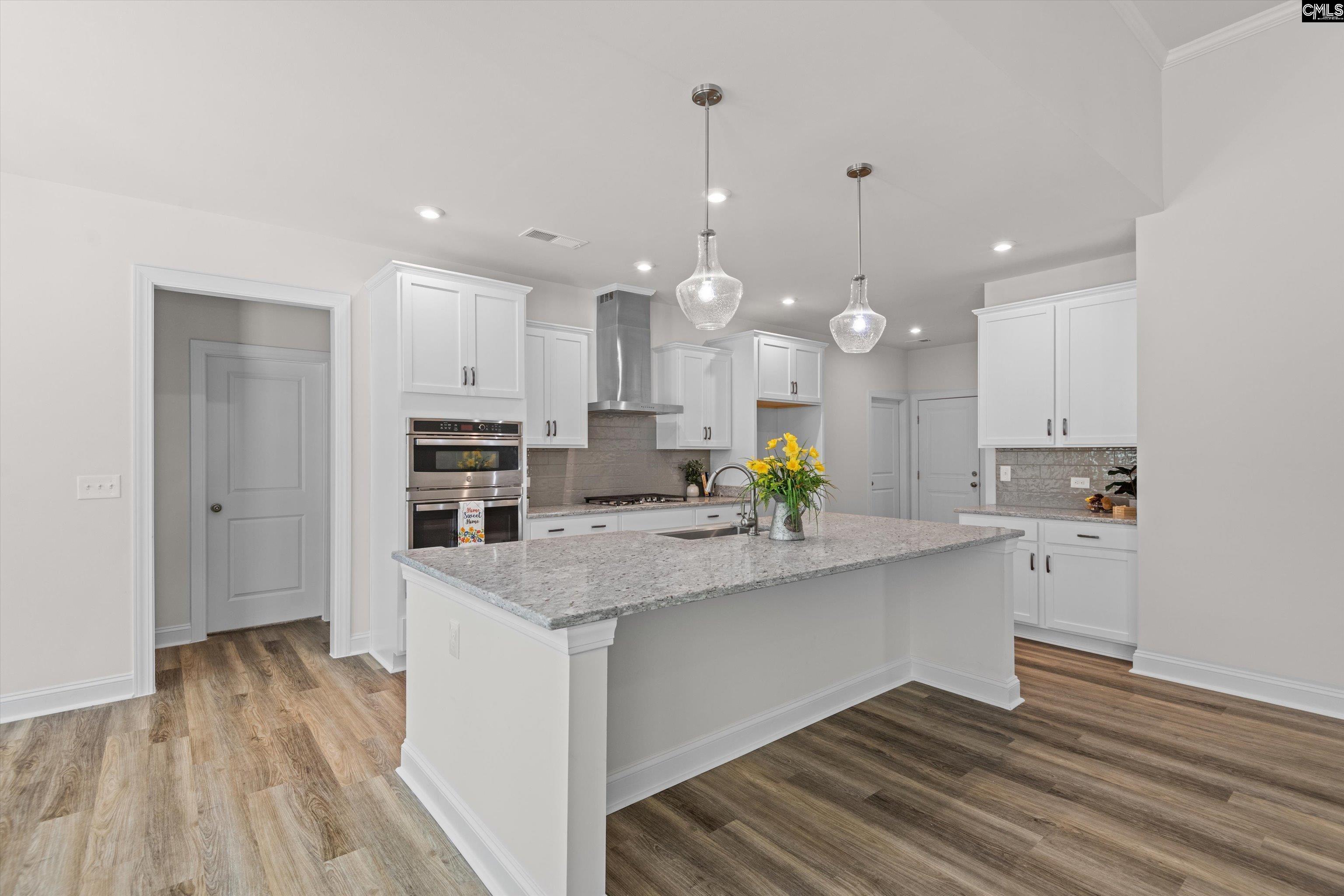 558 Wild Ginger Loop Irmo, SC 29063 - Photo 12 of 42 a kitchen with kitchen island a sink stainless steel appliances and cabinets
