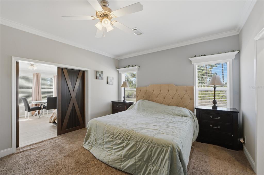 6844 Chad Jason Road St. Cloud, FL 34773 - Photo 31 of 59 a bedroom with a bed and a chandelier