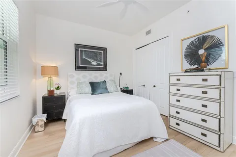 a bathroom with a double vanity sink toilet mirror and shower