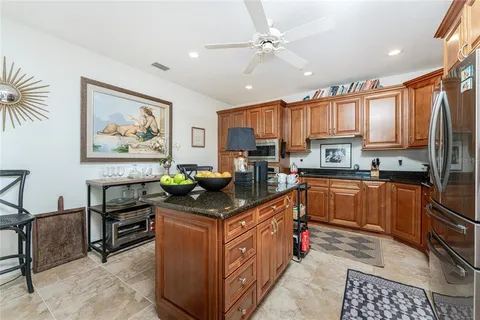 a kitchen with stainless steel appliances granite countertop a stove top oven a sink a counter space and cabinets