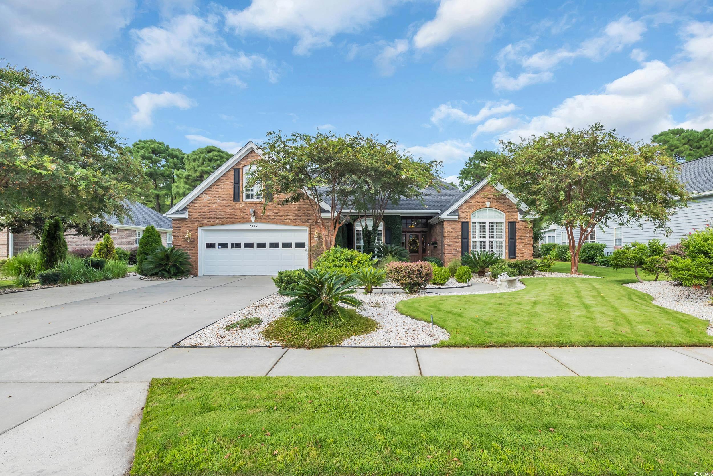 3112 Bayhaven Drive Myrtle Beach, SC 29579 - Photo 1 of 40 View of front of house featuring brick siding, driveway, a front lawn, and an attached garage