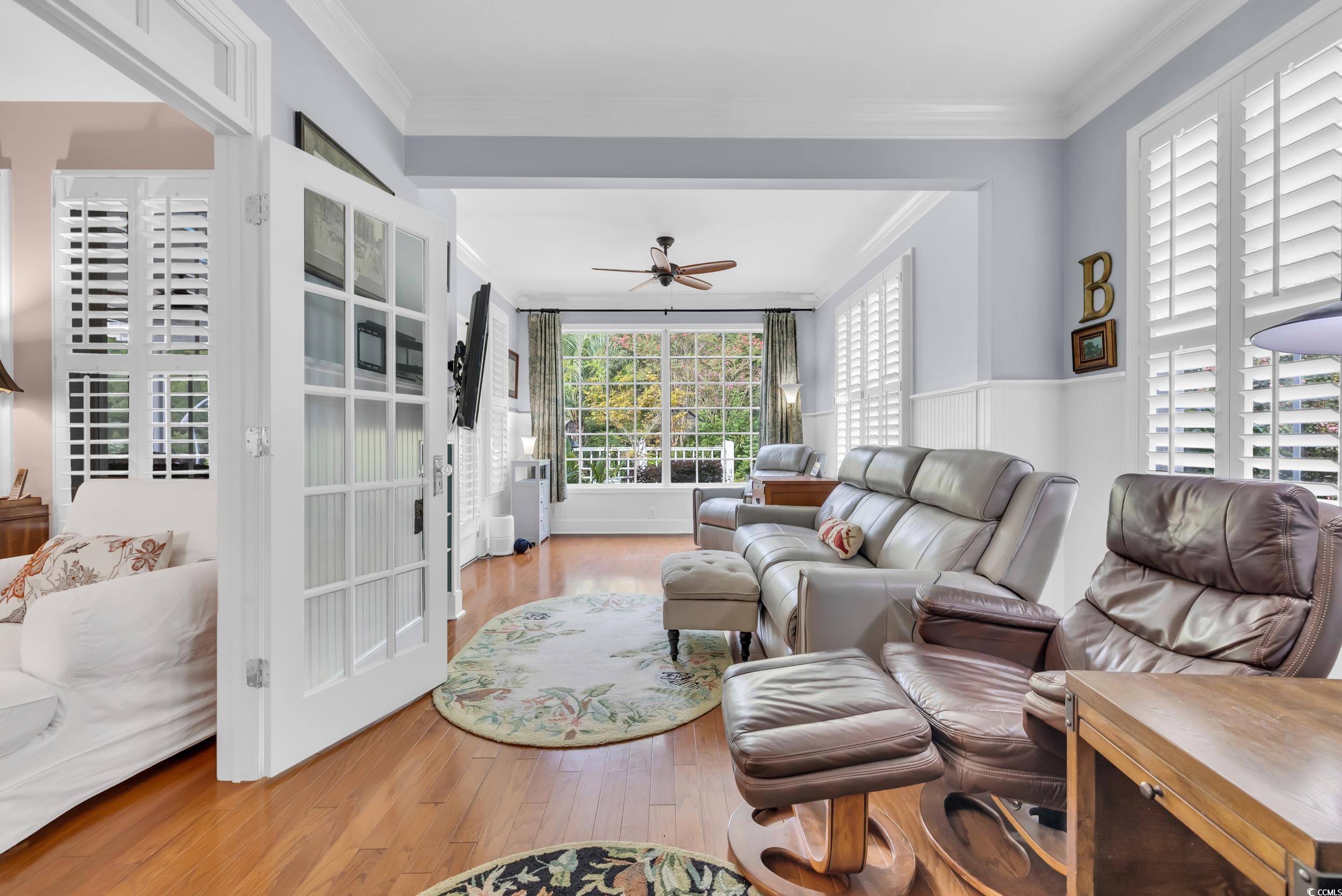 3112 Bayhaven Drive Myrtle Beach, SC 29579 - Photo 16 of 40 Living room featuring wood finished floors, ornamental molding, and a ceiling fan