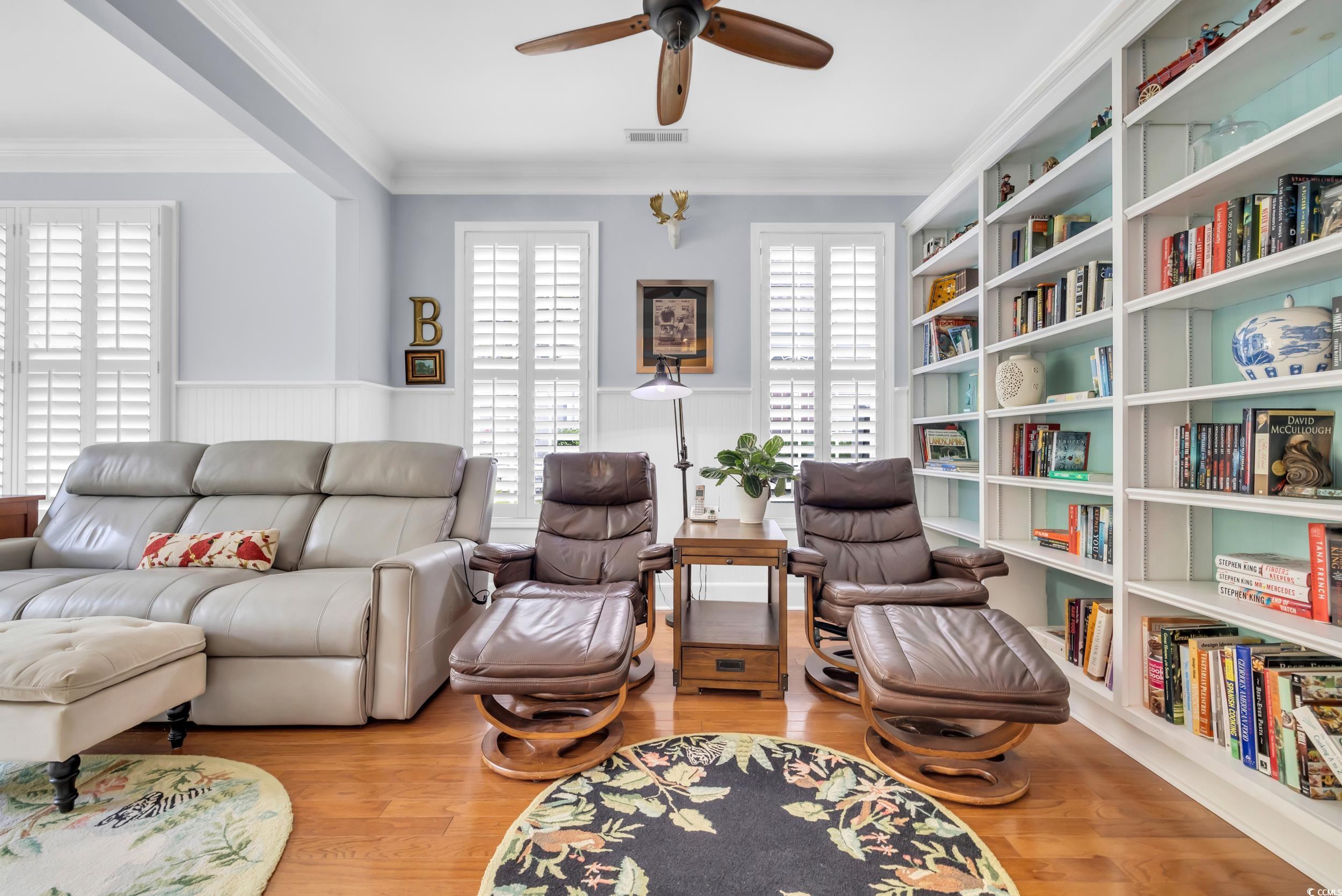 3112 Bayhaven Drive Myrtle Beach, SC 29579 - Photo 17 of 40 Sitting room featuring crown molding, wood finished floors, ceiling fan, and a wainscoted wall