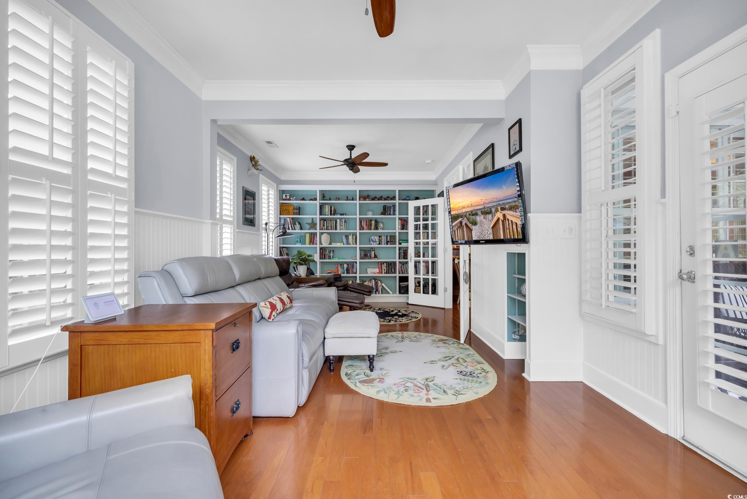 3112 Bayhaven Drive Myrtle Beach, SC 29579 - Photo 18 of 40 Living area with wainscoting, wood finished floors, ceiling fan, and ornamental molding
