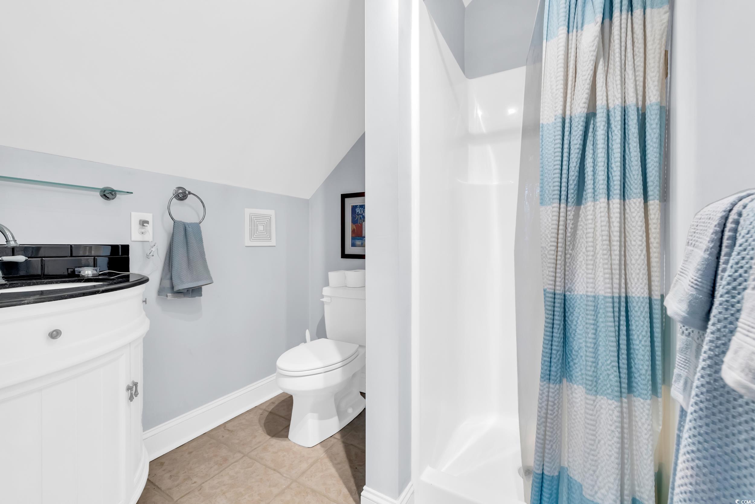 3112 Bayhaven Drive Myrtle Beach, SC 29579 - Photo 21 of 40 Bathroom featuring a stall shower, light tile patterned floors, lofted ceiling, and vanity