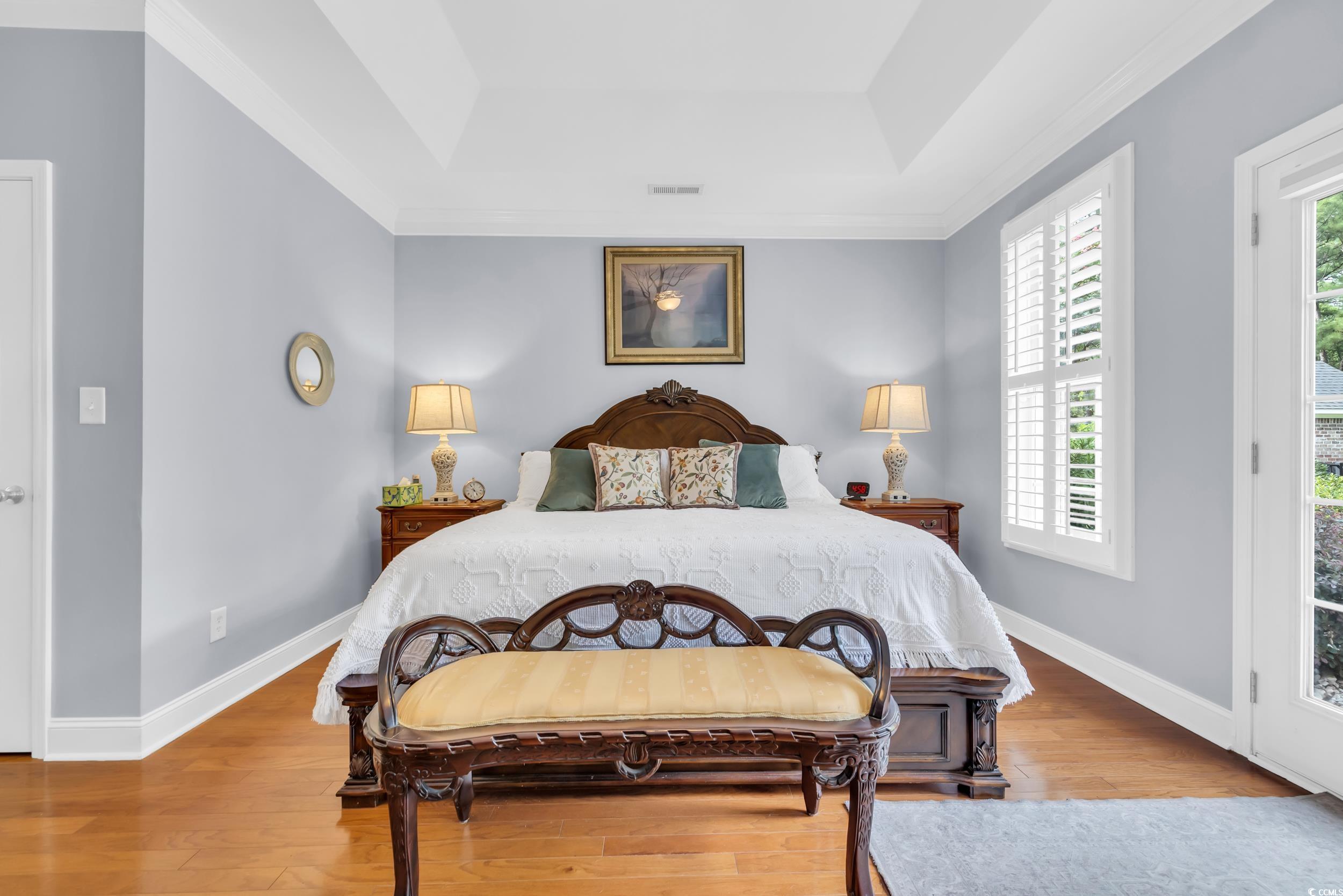 3112 Bayhaven Drive Myrtle Beach, SC 29579 - Photo 25 of 40 Bedroom with access to outside, a raised ceiling, light wood-type flooring, and ornamental molding