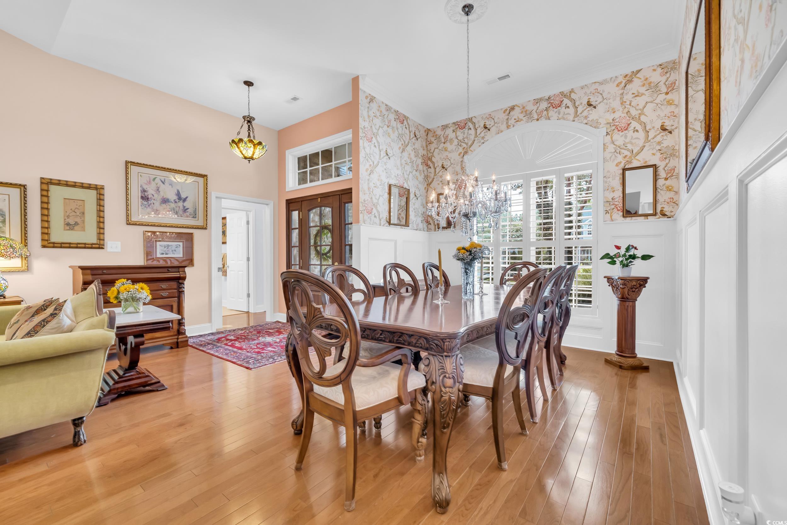 3112 Bayhaven Drive Myrtle Beach, SC 29579 - Photo 7 of 40 Dining room featuring wallpapered walls, plenty of natural light, hardwood / wood-style flooring, a chandelier, and french doors