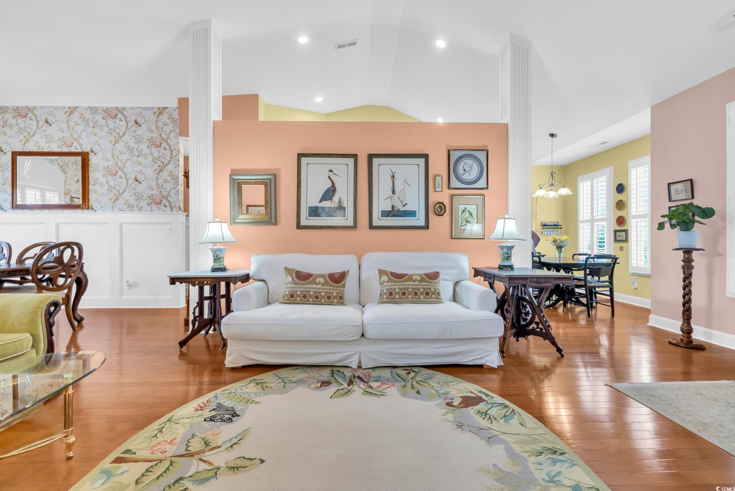 3112 Bayhaven Drive Myrtle Beach, SC 29579 - Photo 9 of 40 Living room featuring wood finished floors, vaulted ceiling, wallpapered walls, and a chandelier
