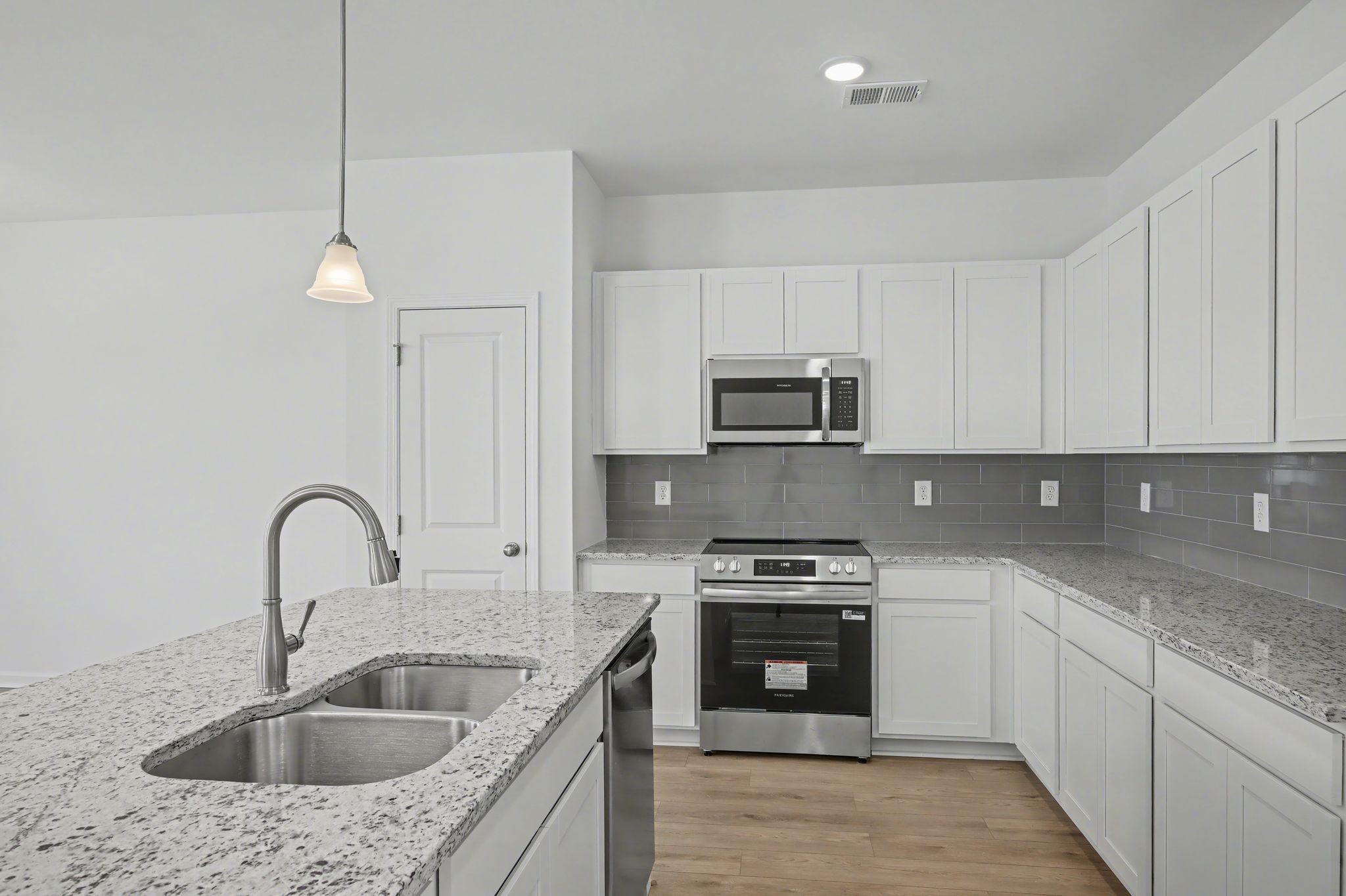 128 Ironhorse Way Dickson, TN 37055 - Photo 24 of 37 a kitchen with stainless steel appliances granite countertop a sink a stove top oven a counter space and cabinets