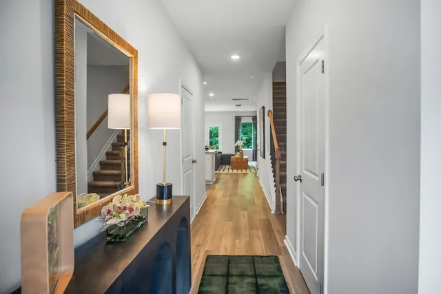 a hallway with a large mirror and furniture