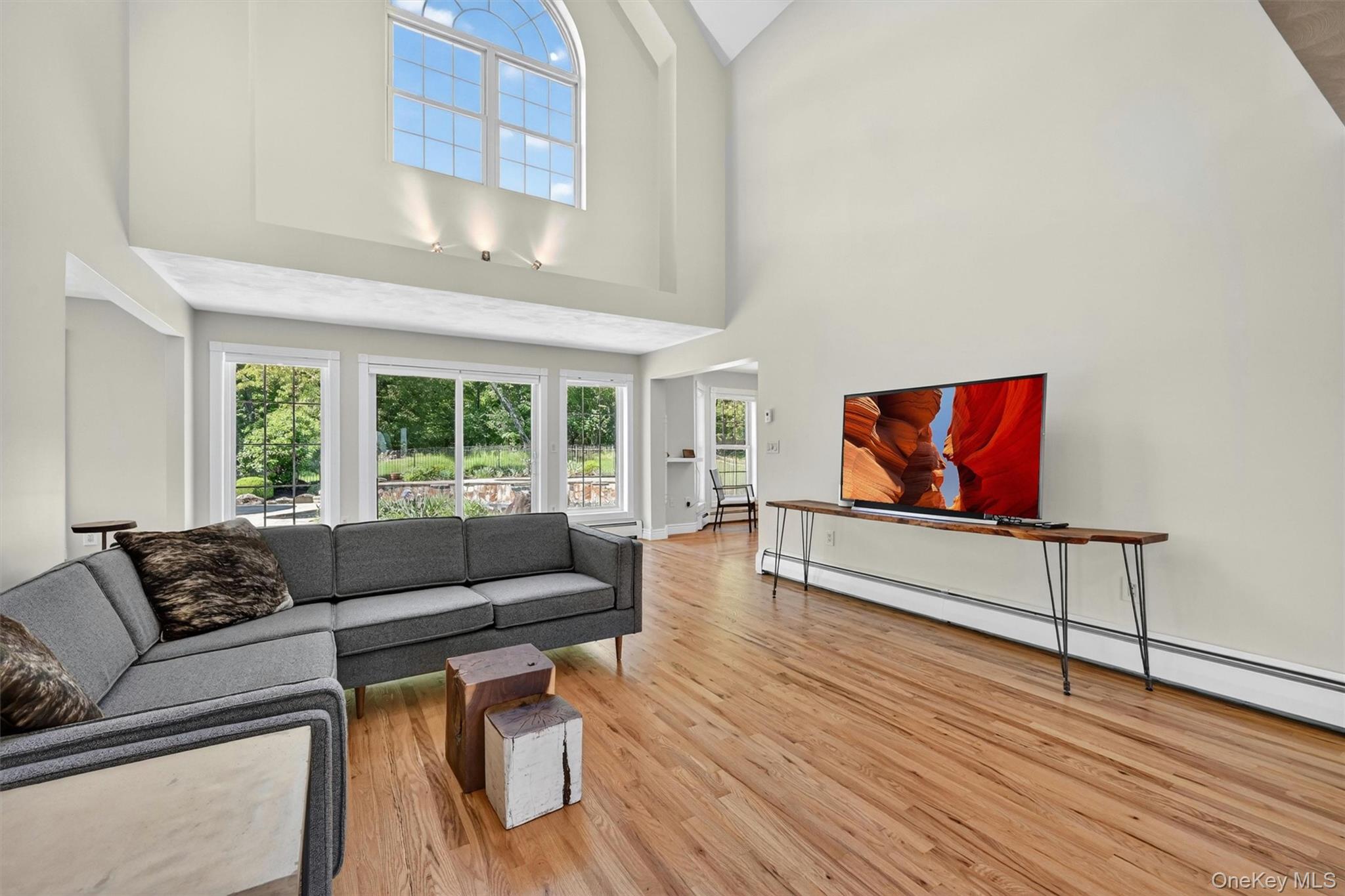 954 Ridgebury Road New Hampton, NY 10958 - Photo 10 of 45 The living room is bright and dramatic, with tall ceilings, expansive windows, and a wonderful connection to the outdoor spaces beyond.